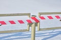 Metal fence with a stretched red and white fencing tape