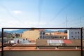 Metal fence view on a urban rooftop skyline on a sunny blue sky