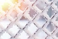 Metal fence wire mesh covered with snow, ice and hoarfrost on a winter sunny day. Frozen hedge texture backdrop. Cold weather Royalty Free Stock Photo