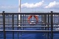 Fences and lifebuoy at the dock where pleasure boats leave on the river Royalty Free Stock Photo