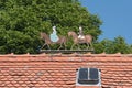 Metal figures two riders, man and woman on the roof of a estate Royalty Free Stock Photo