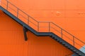 Metal fire escape or emergency exit on Orange Wall of Buliding Royalty Free Stock Photo