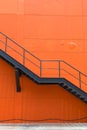 Metal fire escape or emergency exit on Orange Wall of Buliding Royalty Free Stock Photo