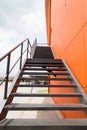 Metal fire escape or emergency exit on Orange Wall of Buliding Royalty Free Stock Photo