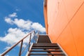 Metal fire escape or emergency exit on Orange Wall of Buliding Royalty Free Stock Photo