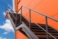 Metal fire escape or emergency exit on Orange Wall of Buliding W Royalty Free Stock Photo