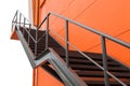 Metal fire escape or emergency exit on Orange Wall of Buliding W Royalty Free Stock Photo