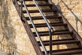 Metal fire escape stairs next to an old stone wall Royalty Free Stock Photo