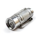 Metal flashlight with clip lying on white background Royalty Free Stock Photo