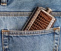 Metal flask for alcohol in the pocket of jeans.