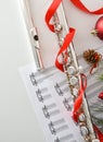 Metal flute detail music and Christmas decoration on white table Royalty Free Stock Photo