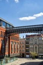 metal footbridge and Red brick building in an old brewery in Poznan Royalty Free Stock Photo