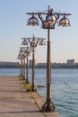 Metal forged lights on promenade of river.