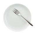 Metal fork in a ceramic plate isolated Royalty Free Stock Photo