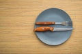 Metal fork and knife on a wooden table Royalty Free Stock Photo