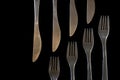 Metal forks and knives on a black background. top view on stainless knives and forks with copy space