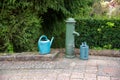Metal fountain and watering can