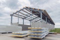 Metal frame of the building with a sandwich panel of insulation on the wall. Construction of a new industrial building. Modern