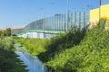 Sound-absorbing screens along the highway and the creek.