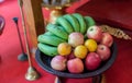 Metal fruit bowl on a wooden surface. Close. Bananas, oranges and apples. Mix of fresh apple,banana,orange, in a basket. Royalty Free Stock Photo