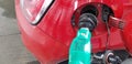 Rubber fuel nozzle inside the gas tank of mini sport car filling gasoline in self service station