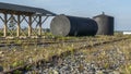 A metal fuel tank in an antique railway yard. Old black Fuel Tank on the village railroad station.