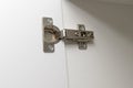 Metal furniture hinge mounted on the door of cabinet