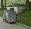 Metal garbage cans on wheels. Two trash cans on the street. Royalty Free Stock Photo
