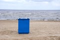 Metal garbage container on sea resort beach Royalty Free Stock Photo