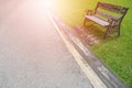 Metal garden chair on green grass with burst light