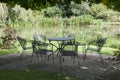 Metal garden furniture at water Royalty Free Stock Photo