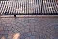 Metal gate on casters on the background of paving slabs