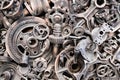 Metal gears background. Old and rusty spare parts for industrial machines in a landfill. Royalty Free Stock Photo