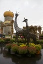 Metal Giraffe Statues Great Guests at Rainy Rural Pumpkin Patch