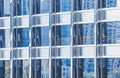 Metal glass facade blue colour of skyscraper. Fragment of the modern building. Many windows pattern Royalty Free Stock Photo