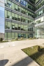 Metal and glass facade with hedged gardens at the entrance of an office building Royalty Free Stock Photo