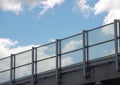 Metal and glass railing with blue sky in perspective