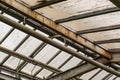 Metal and glass roof of a greenhouse with pipes Royalty Free Stock Photo