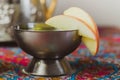 Metal goblet with a refreshing drink decorated with apple slices