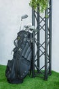 Metal golf clubs in a special black golf bag.