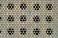 Metal grate with geometric round holes in circular grid pattern for design or texture purposes Royalty Free Stock Photo
