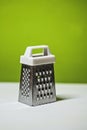 Metal grater with plastic white handle