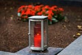 Metal grave lamp with burning candle Royalty Free Stock Photo