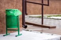 Metal green gerbage bin for rubbish. Public trash can background. Detail of outdoor infrastructure. Royalty Free Stock Photo