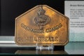 Metal Grenadier Guards badge on display in an army war museum in Aldershot, UK