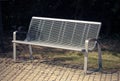 Metal bench on the sidewalk Royalty Free Stock Photo