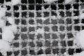 Metal grid covered by snow