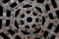 Metal grid of manhole cover against black background Royalty Free Stock Photo