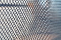 Metal grid with numerous small cells on light background Royalty Free Stock Photo