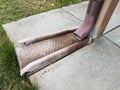 Metal gutter downspout pipe and grey cement